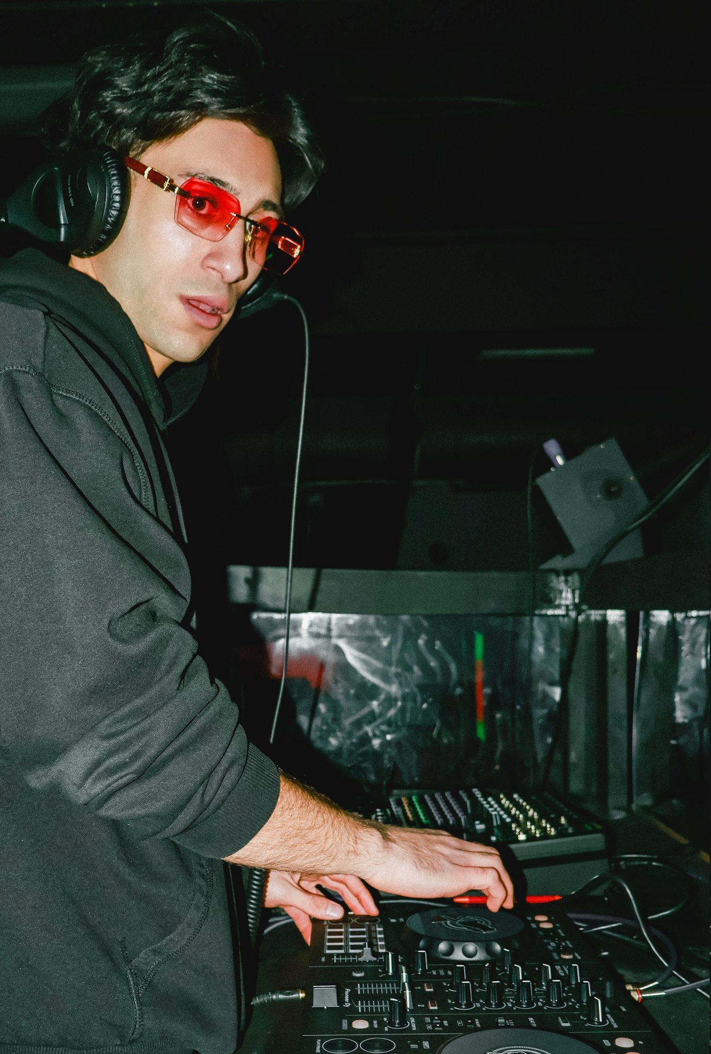 Jozan in red-tint glasses looking back over the decks
