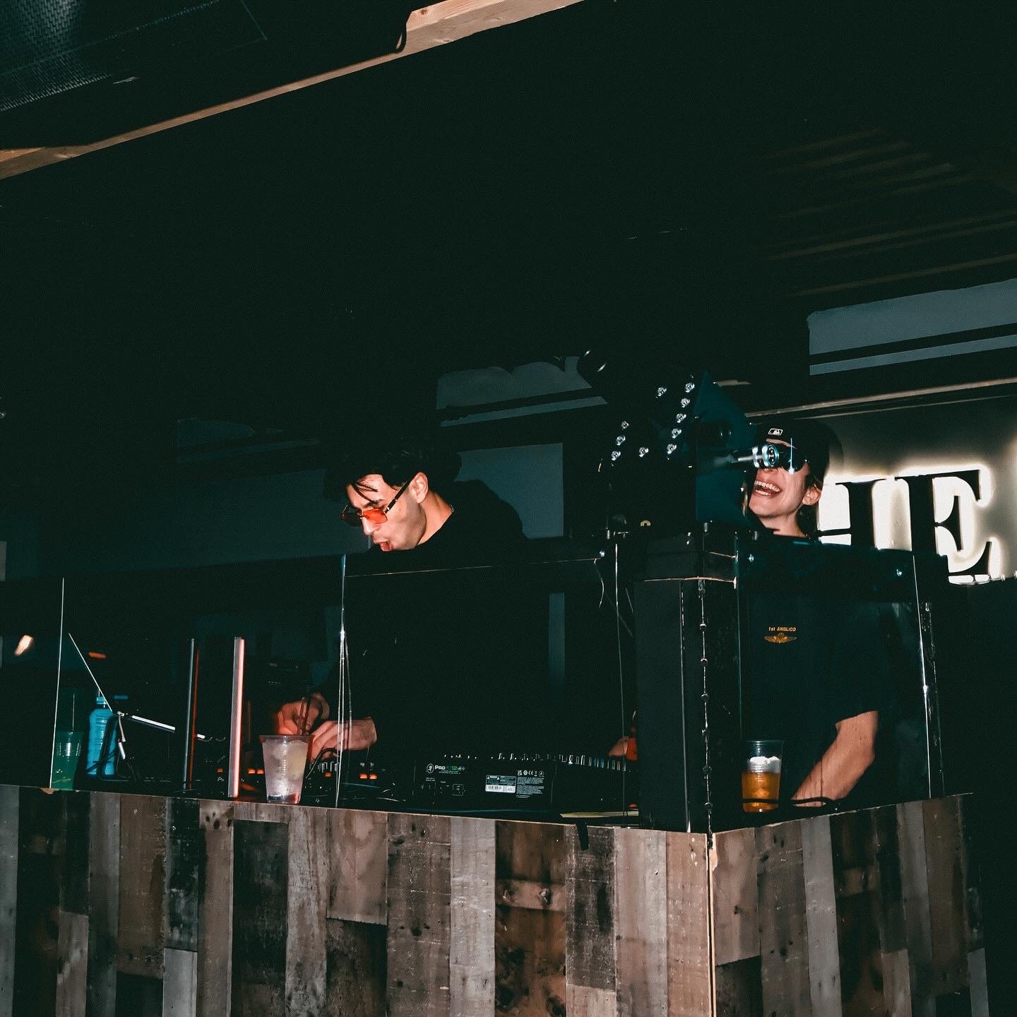 Jozan behind a wooden DJ booth